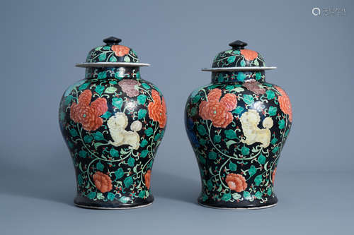 A pair of Chinese famille noire vases and covers, 20th C.