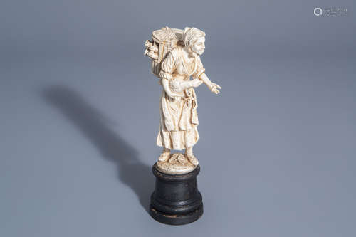 A carved ivory figure of a lady with poultry on wooden base, probably Dieppe, France, 19th C.