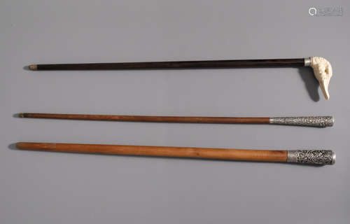 Two Chinese walking sticks with silver handles and one with a duck head shaped ivory handle, 19th/20