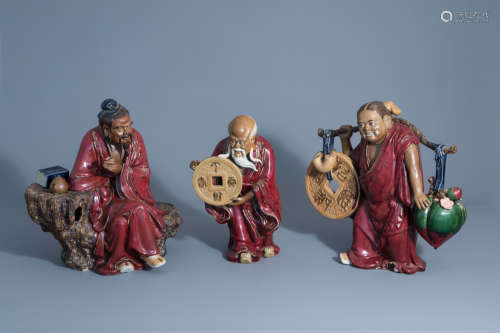 Three Chinese Shiwan sang de boeuf glazed pottery figures depicting scenes from daily life, seal mar
