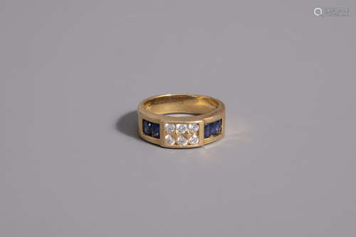 An 18 carat yellow gold ring set with four blue sapphires and six diamonds, 20th C.