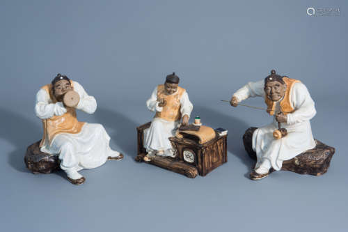 Three Chinese Shiwan pottery figures of musicians, seal marks, 20th C.