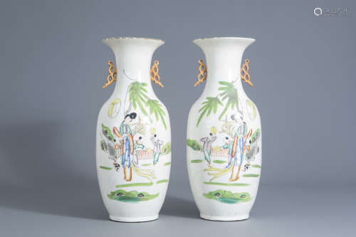 A pair of Chinese famille rose vases with figures in a garden, 20th C.