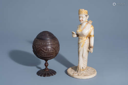 An Indian carved coconut beaker and cover and an alabaster figure of a deity with gilt design, 19th/