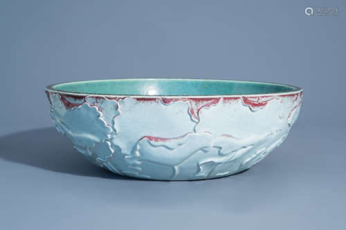 A Chinese porcelain relief decorated wash basin bowl with sang de boeuf accents, 20th C.