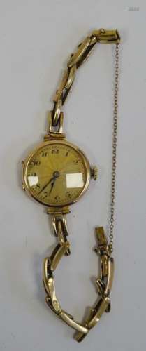 Gold-coloured lady's wristwatch with Arabic numerals to the dial