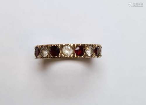 Gold-coloured metal, diamond and garnet eternity ring