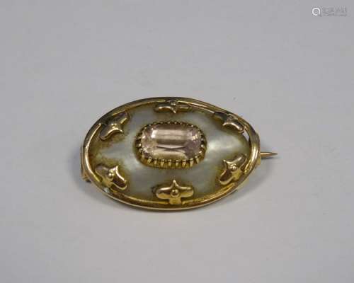 Victorian gold coloured and metal mounted mother of pearl and pink stone oval shaped brooch with