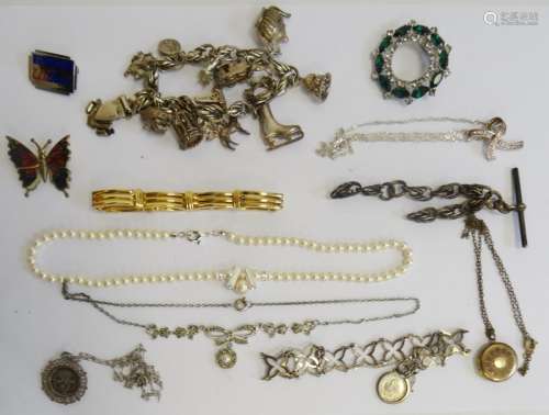 Silver charm bracelet, costume rings, silver chains, beaded necklaces, brooches in a jewellery box