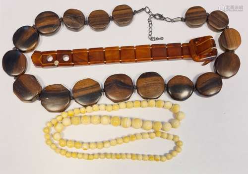 19th century ivory-effect graduated beads, a rosewood carved beaded necklace and an amber-effect