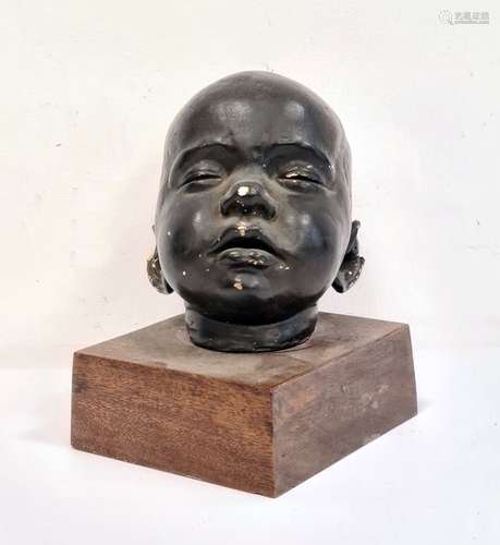 Painted plaster baby's head on wooden plinth base, unsigned, 17cm high in total