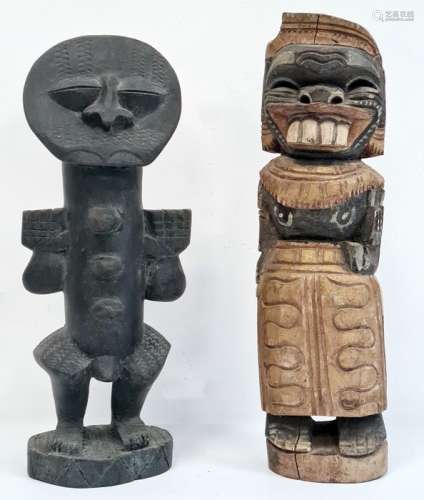 Carved African figure, possibly West African, standing with arms raised and another carved female