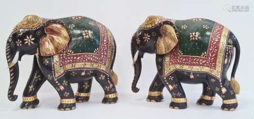 Pair of carved and decorated elephants, gilt highlighted, 26.5cm high (2)