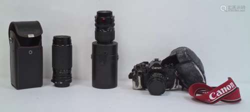 Canon A-1 camera, a Sigma Jessop 52mm 1A lens in case and a Sigma 55MM Skylight (1B) zoom lens in