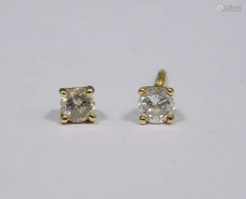 Pair of gold and diamond stud earrings (gold unmarked) (one earring broken), each earring approx 0.