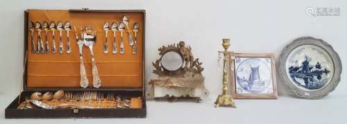 Cased set of flatware, a framed Delft tile, a Delft plate in pewter mount, an ormolu clock mount (