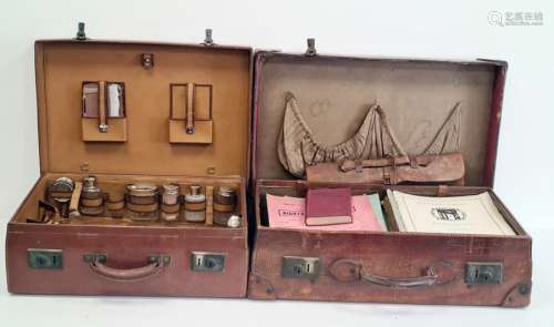 Leather suitcase with various music sheets and a leather suitcase with dressing travelling set to