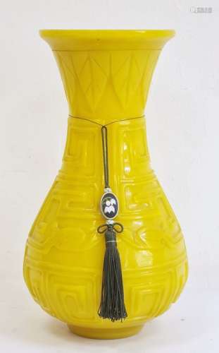 Chinese carved yellow Beijing glass vase, of baluster form with everted neck, carved with key