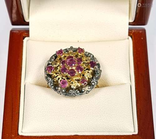 Silver-gilt and ruby cluster ring set seven stones in flowerhead pattern to centre, with surround of