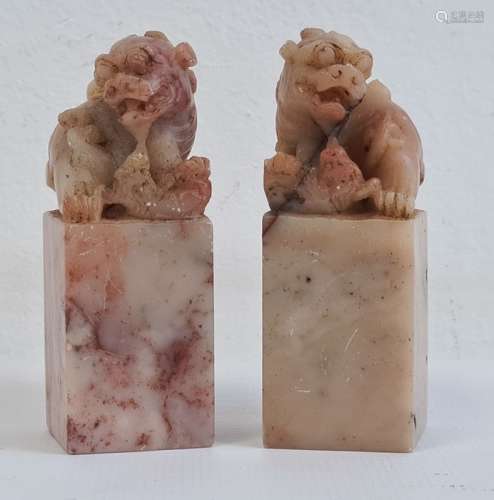 Pair of Chinese carved hardstone models of dogs of fo, on square bases, 6.5cm high (2)