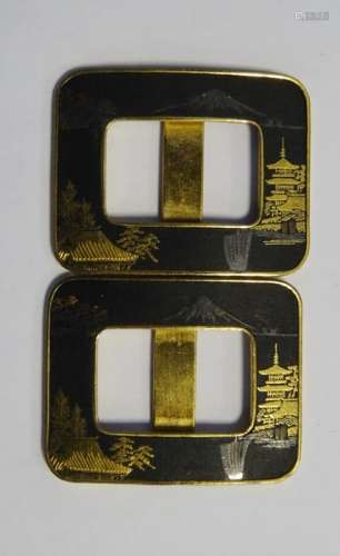 A pair of Japanese niello buckles, c.1930, in gold and black with mountain and pagoda scenes, mark