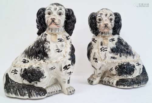 Pair of pottery Staffordshire-type model spaniels in black and white, 35cm high (2)