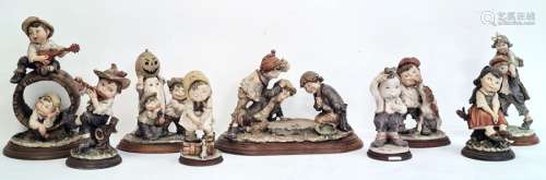 Nine Capodimonte figures by G Amani to include 'Gullivers World' and other figures of children at
