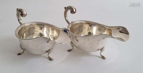 Pair of Edward VIII silver sauce boats on splayed feet, with egg and dart decoration to rim,