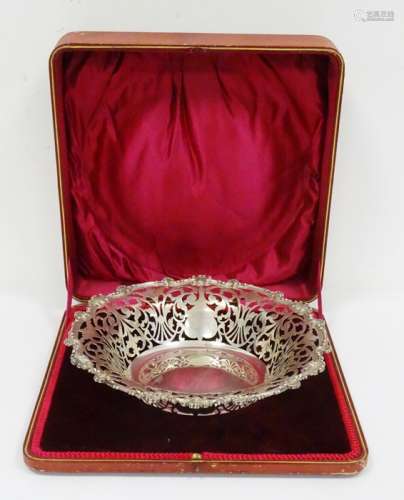 Early 20th century silver bowl with pierced scroll rim, scalloped and scroll relief edges, in red