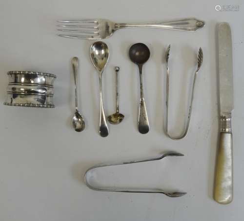 Silver napkin ring, a small silver tea fork, two silver sugar nips, miniature spoons and a mother-