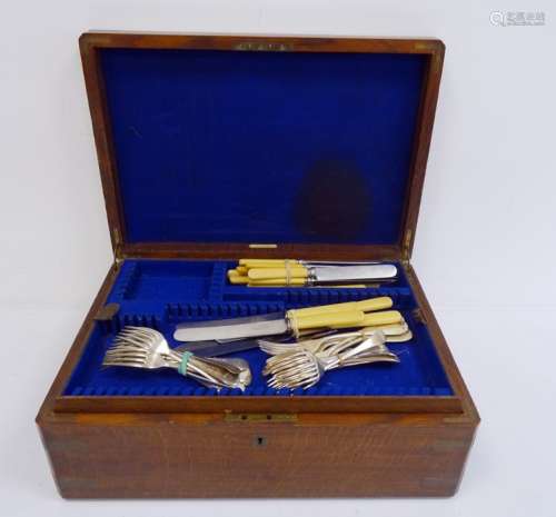 Small quantity of flatware, knives with ivorine handles in a large wooden canteen