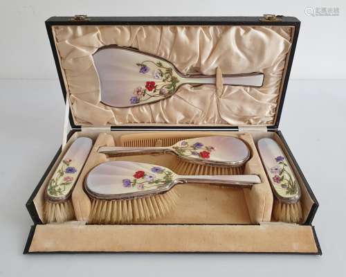 1930's silver and enamel mounted dressing set comprising of four brushes and mirror, cased, the pale