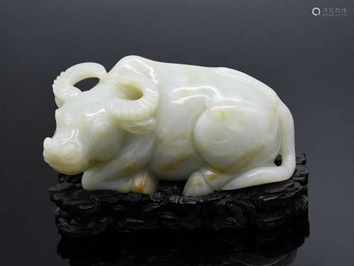 A HETIAN JADE CARVED BUFFALO WITH STAND