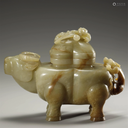 A WHITE AND RUSSET JADE CARVING OF A BUFFALO