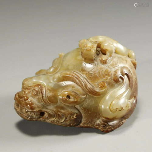 AN ARCHAIC WHITE AND RUSSET JADE MYTHICAL …
