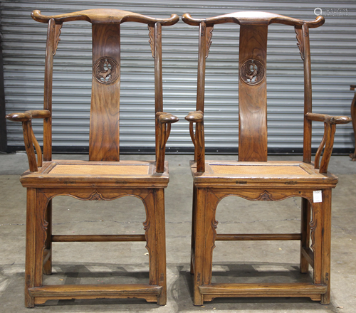 A pair of Chinese elmwood yoke-back chairs