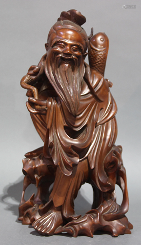 A Chinese Boxwood Figure of a Standing Fisherman