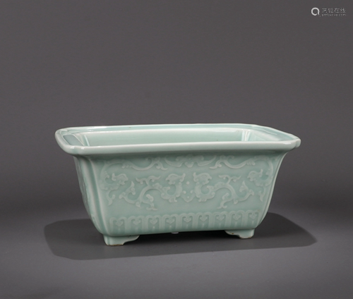 A CHINESE CELADON MOLDED DRAGON JARDINIER…