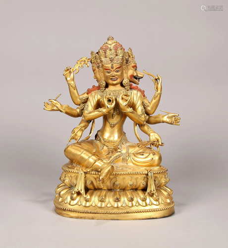 A SINO-TIBETAN GILT BRONZE FIGURE OF GUARDI…