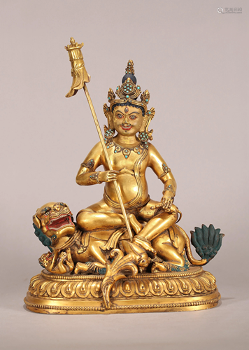 A SINO-TIBETAN GILT BRONZE FIGURE OF GUARDI…