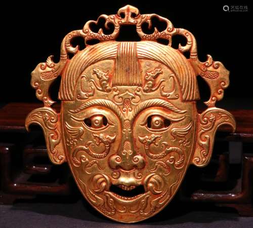 A CHINESE BRONZE GILDING MASK