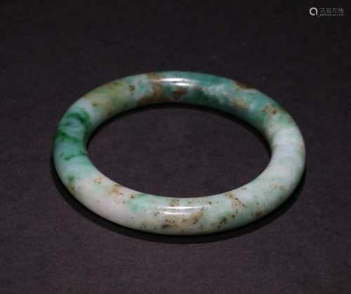 A CHINESE GREEN JADE BRACELET