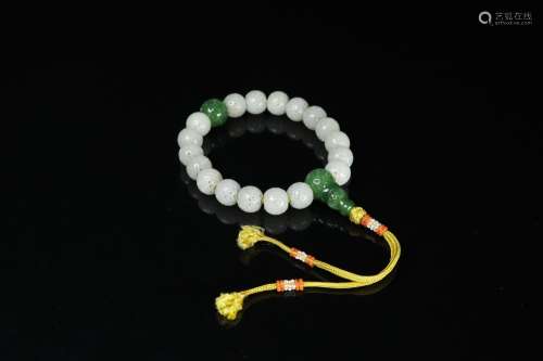 A HAND STRING OF HETIAN JADE SEED MATERIAL WITH MONEY PATTERN