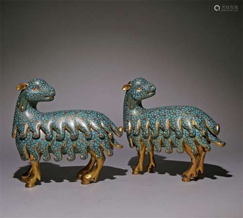 A PAIR OF QING DYNASTY QIANLONG CLOISONNE SHEEP ORNAMENTS