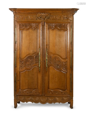 A Louis XV Provincial Style Carved Walnut Armoire