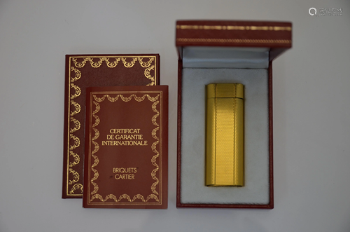 Must de Cartier - A gilt metal cigarette lighter