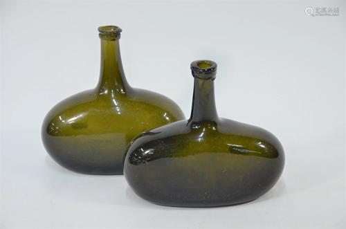 A pair of antique olive-green glass bottles