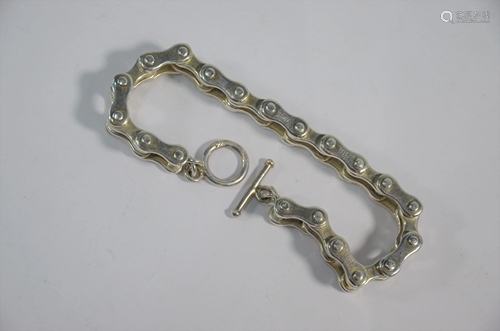 A white metal bracelet in the form of a bicycle chain