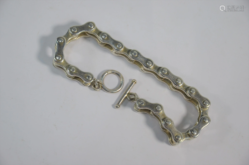 A white metal bracelet in the form of a bicycle chain