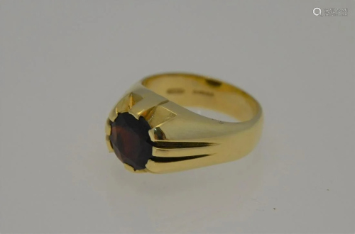 A 15ct yellow gold ring with circular claw set garnet